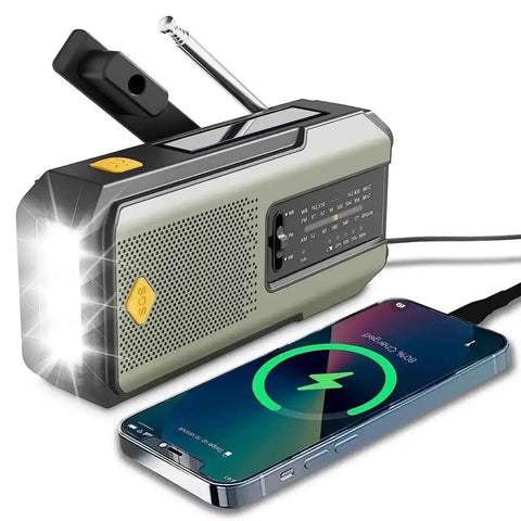 Silver emergency radio with wireless phone charging pad and flashlight for off-grid trips, blackouts, and storms.