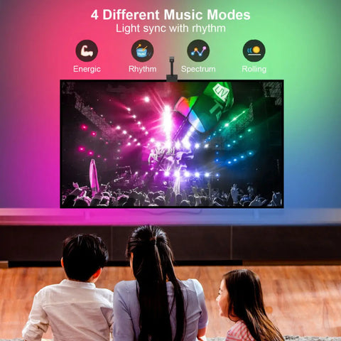 A dark living room setup enhanced by immersive, multi-color background lighting glowing behind a large television screen.