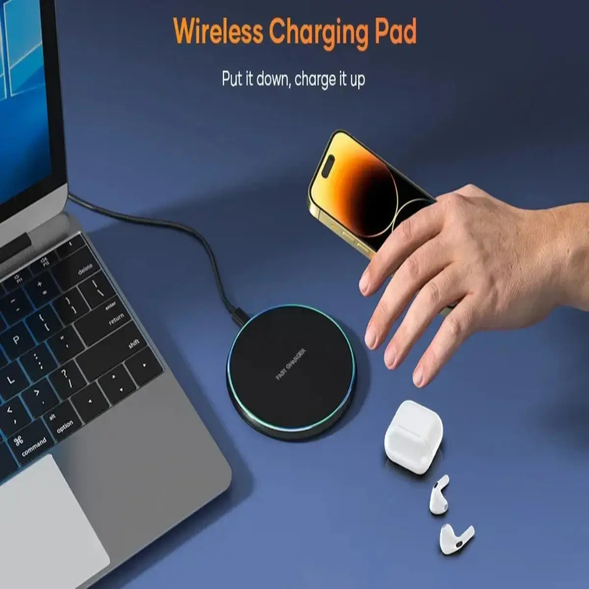 Hands placing a smartphone onto a slim wireless charging pad next to a laptop on a clean workspace.